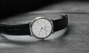 Elegant Piaget-klocka med vit urtavla och svart alligatorrem, perfekt som klocka till smoking.