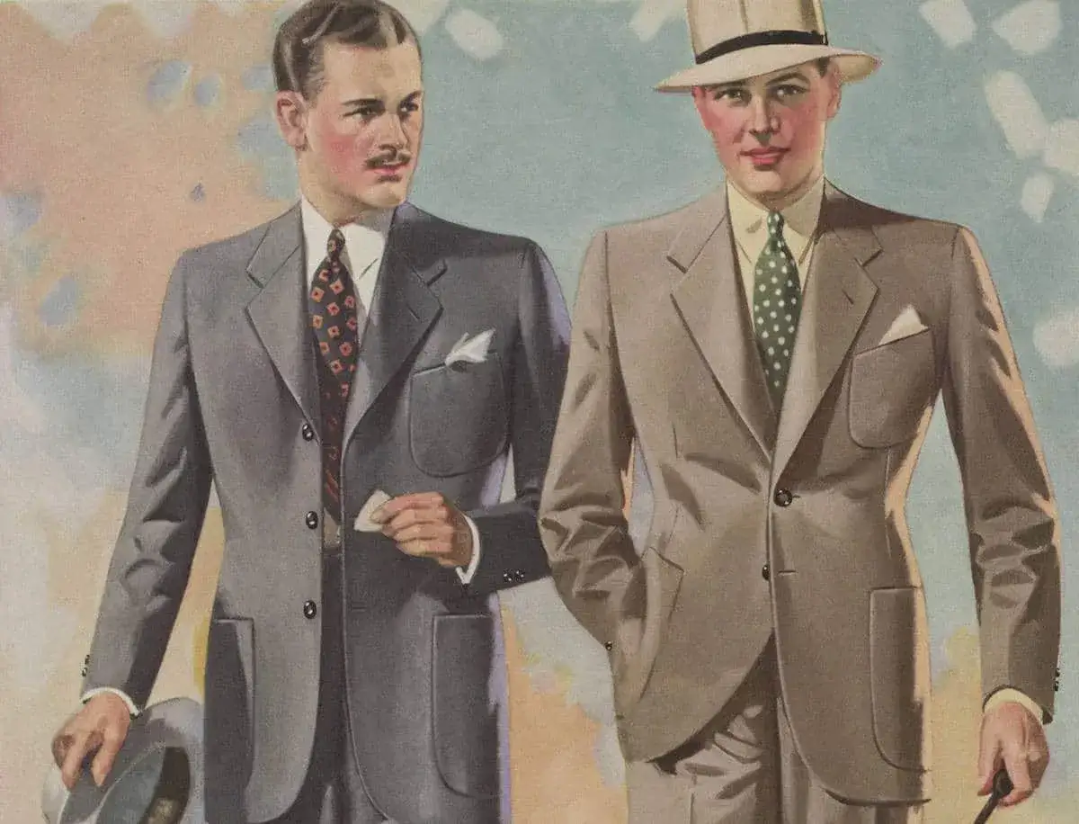 Tv&aring; m&auml;n i kostymer fr&aring;n mode 1930-talet. Den ena med gr&aring; kostym, m&ouml;nstrad slips och hatt. Den andra i ljusbrun kostym, prickig slips och hatt.