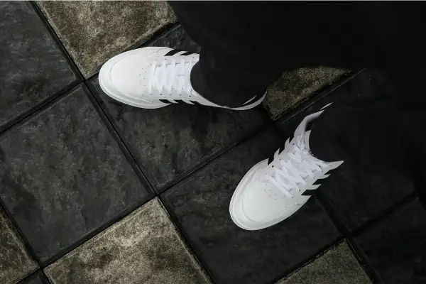 Vita Adidas-skor på mörka plattor. Enkla steg för att få vita skor vita igen.