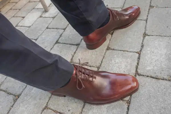 Ett par eleganta bruna läderskor med snörning, som visar hur lång tid det tar att gå in skor för en perfekt passform.