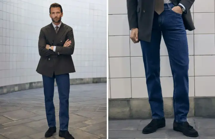 Man i mörk kavaj och blå jeans, med armarna i kors. En stilren kombination för en modern look.